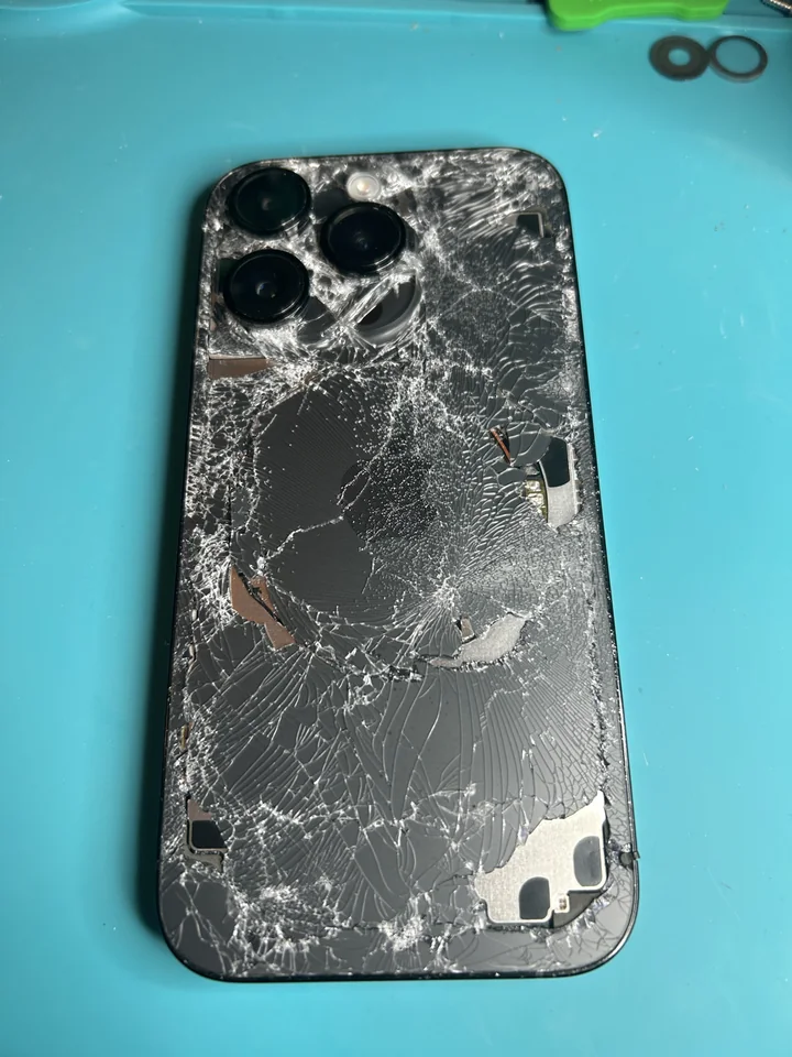 iPhone 14 Pro with severely shattered rear glass