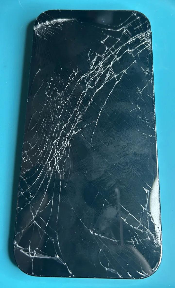 iPhone 14 Pro with heavily cracked front screen